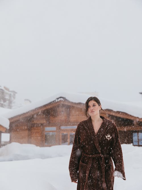 Woman in Fur Coat Walking While It's Snowing