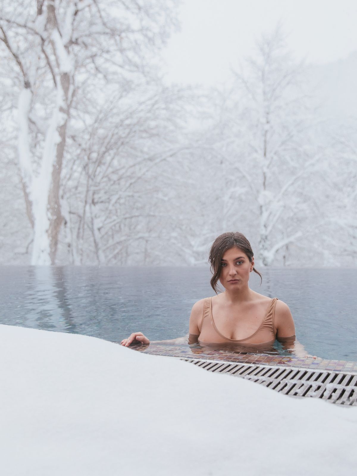 Heated outdoor pool with steam rising in winter