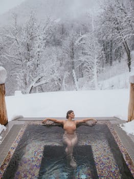 A woman enjoying a hot tub amidst a snowy forest landscape, creating a serene winter retreat.