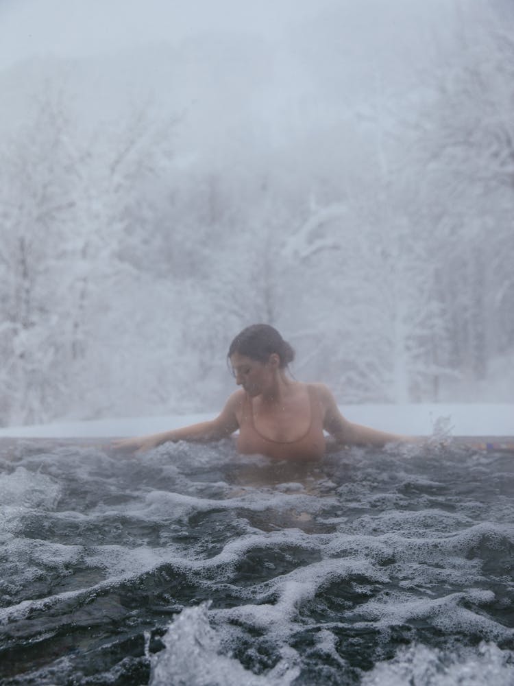 A Woman Relaxing On A Jacuzzi During Winter