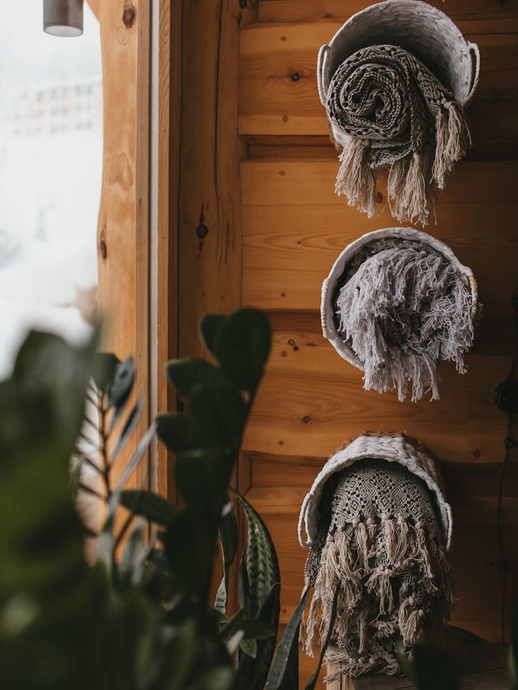 Towels On Basket Hanging On Wooden Wall