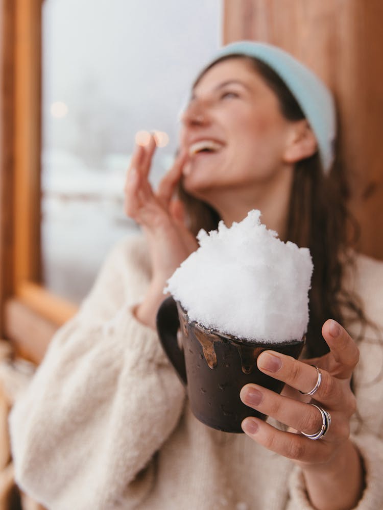 A Woman Holding A Cup With Crushed Ice