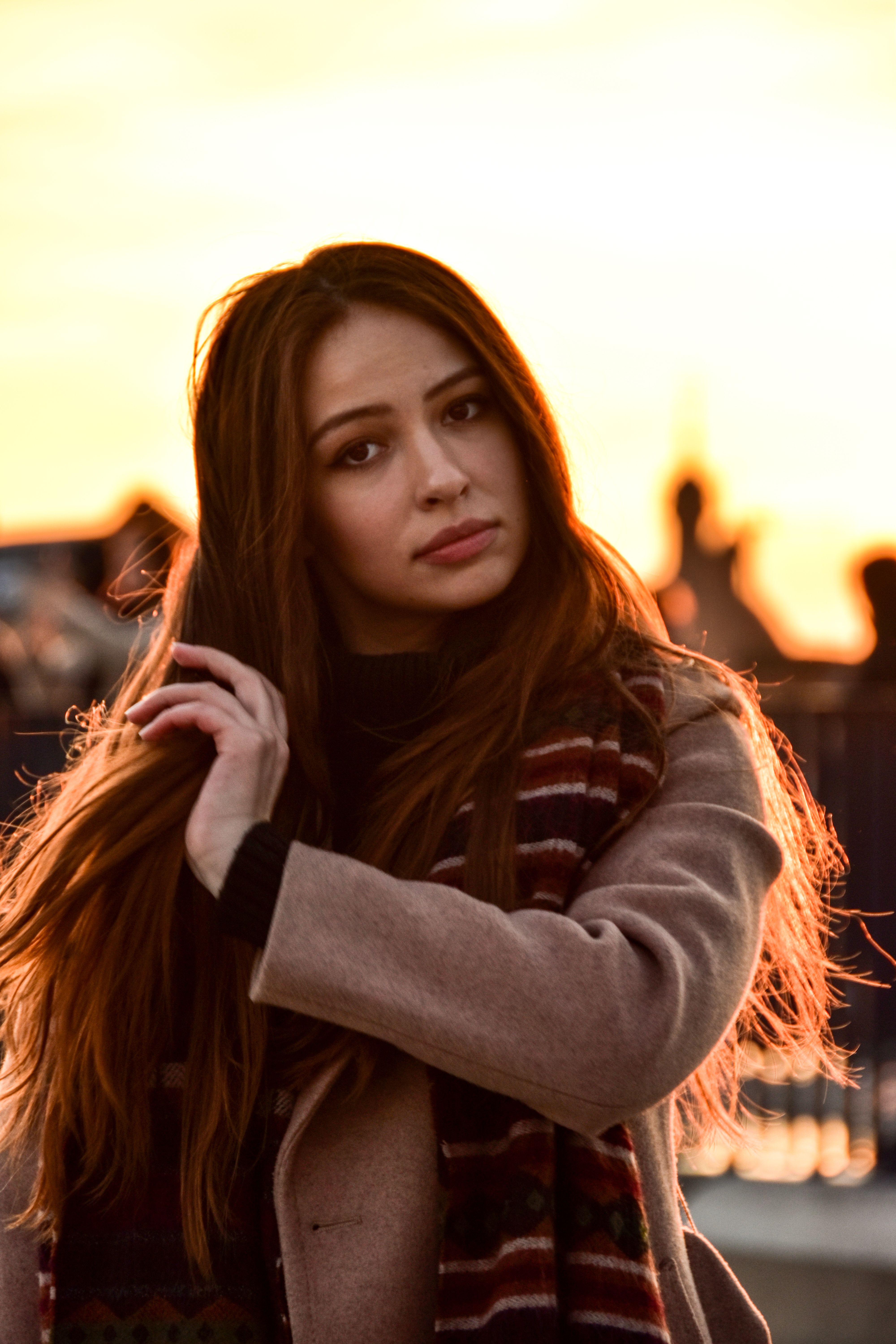 Woman in Brown Coat Holding Her Hair · Free Stock Photo