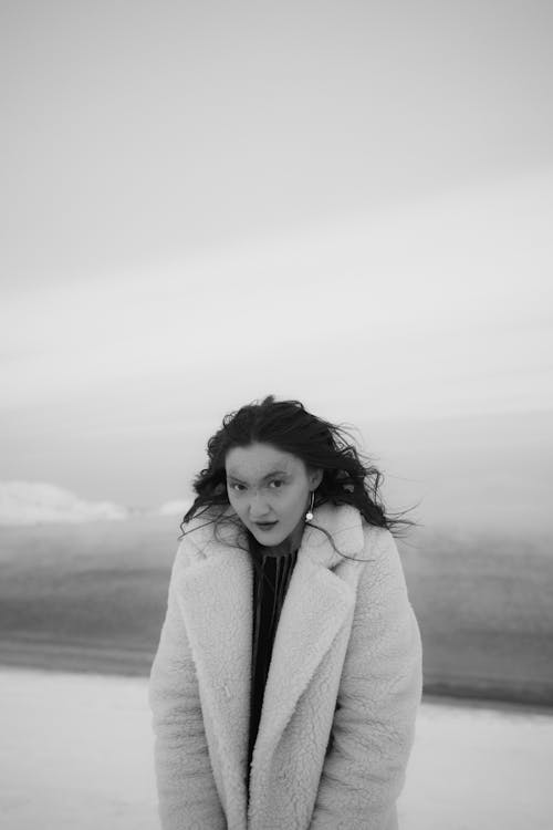 Grayscale Photography of a Woman in Winter Jacket Seriously Looking at the Camera