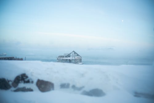 An Old Broken House on a Snow Covered Landscape