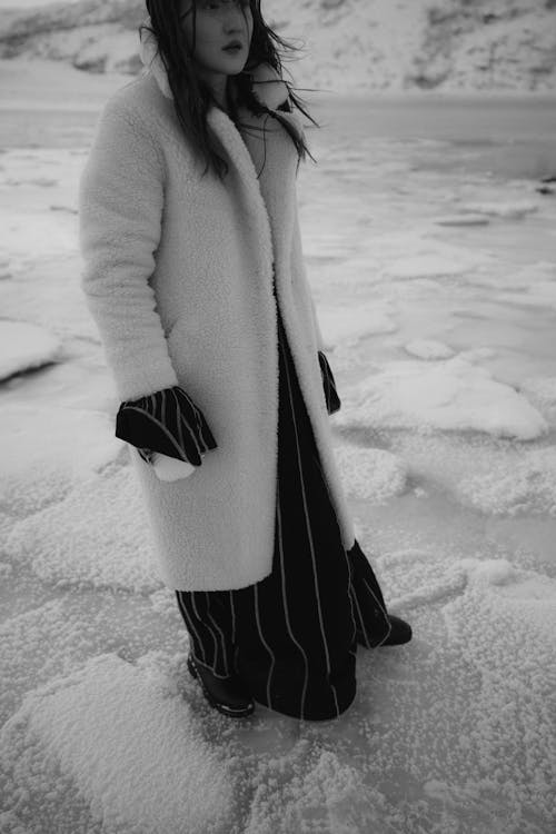 A Woman Standing over a Frozen Beach Shore