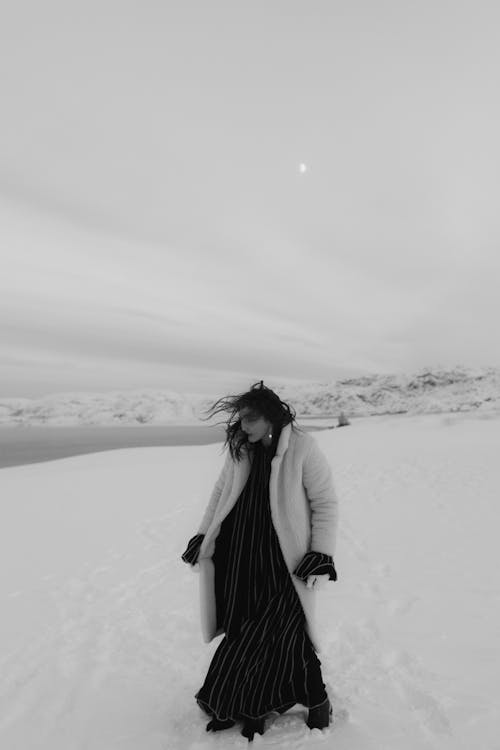 A Grayscale of a Woman Wearing a Fur Coat