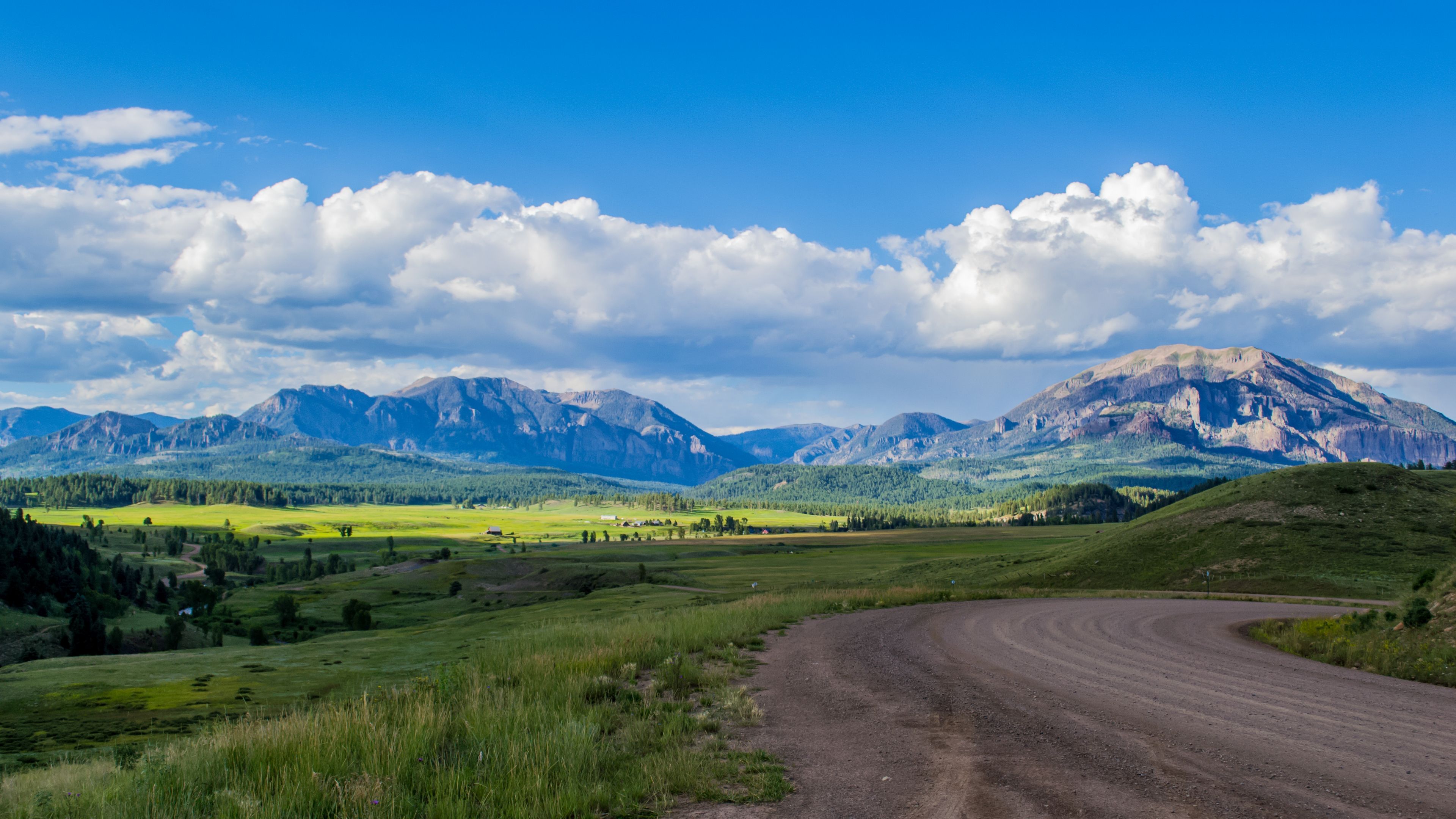 Green Grass Field near Mountains under the Cloudy Blue Sky · Free Stock ...