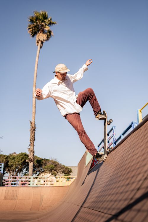 Free A skilled skateboarder executes a trick on a ramp in Cayucos Skate Park, capturing the essence of street sports. Stock Photo