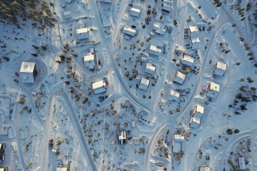 Aerial shot of a snow-covered village in Älvdalen, Sweden, showcasing winter beauty.