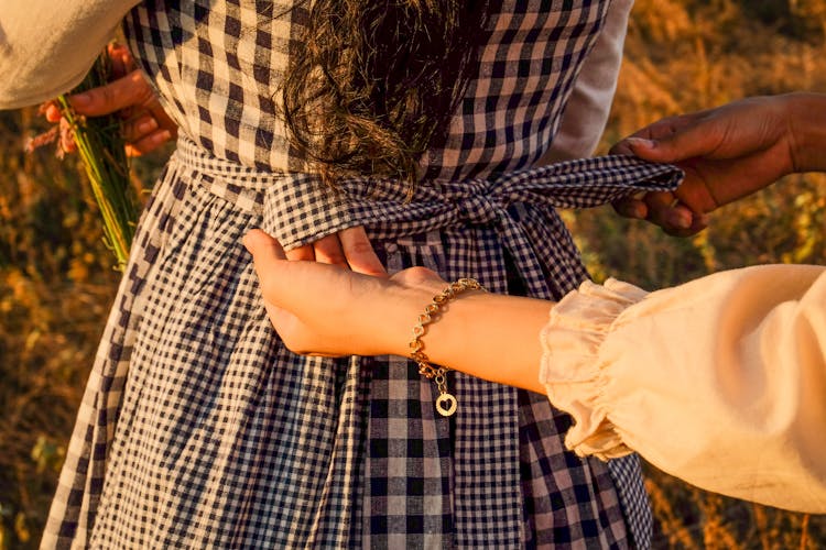 Hands Tying The Ribbon Of A Dress