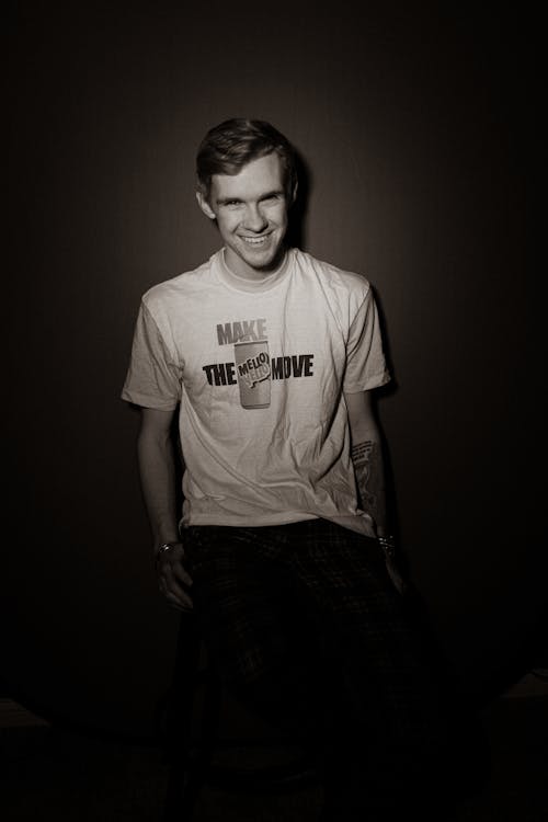 Man Smiling at the Camera on a Black Background