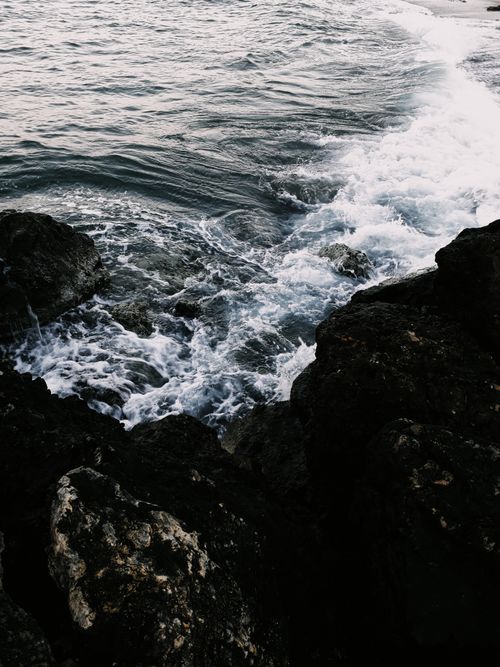 Free Dynamic seascape capturing waves crashing against rocky shore, showcasing nature's power. Stock Photo