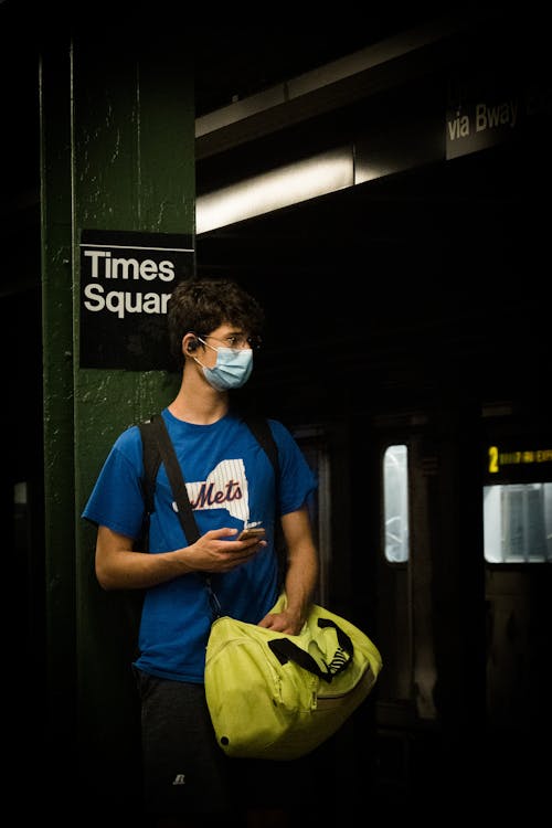 A Man Wearing a Face Mask in a Subway Station