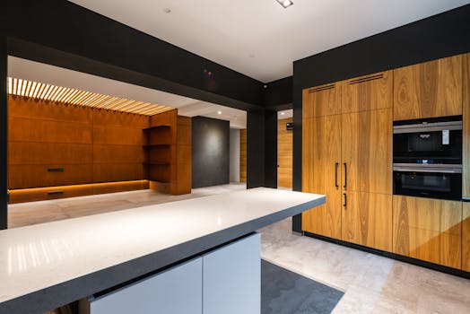Contemporary sleek kitchen interior with wooden cabinets and polished surfaces.