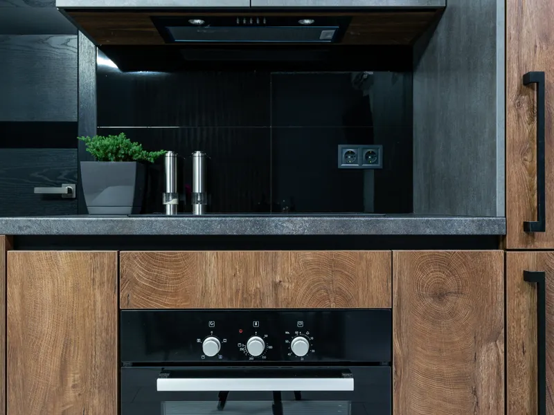 Kitchen with wooden cabinets, black accents and modern appliances Kitchen with wooden cabinets, black accents and modern appliances