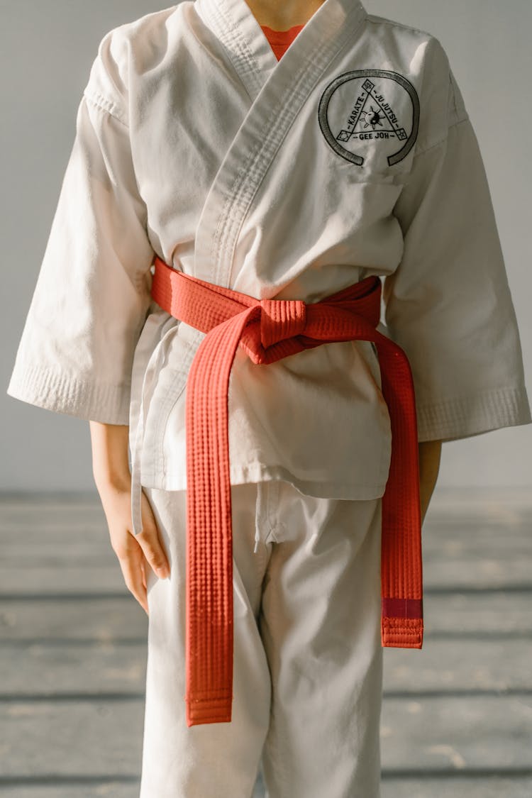 Close-Up Shot Of A Kid Wering White Dobok And Red Belt