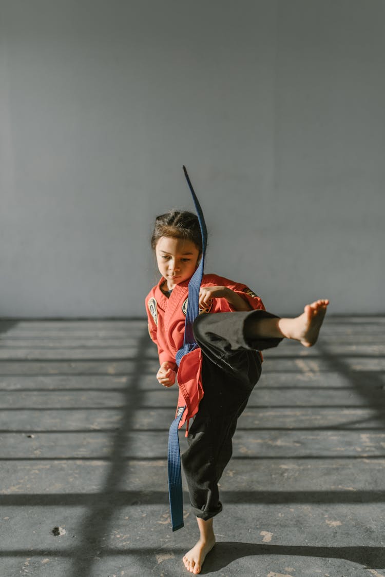 Girl Wearing Red Dobok And Blue Belt