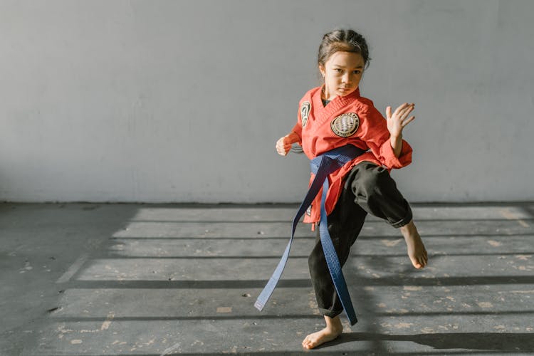 Girl Wearing Red Dobok And Blue Belt