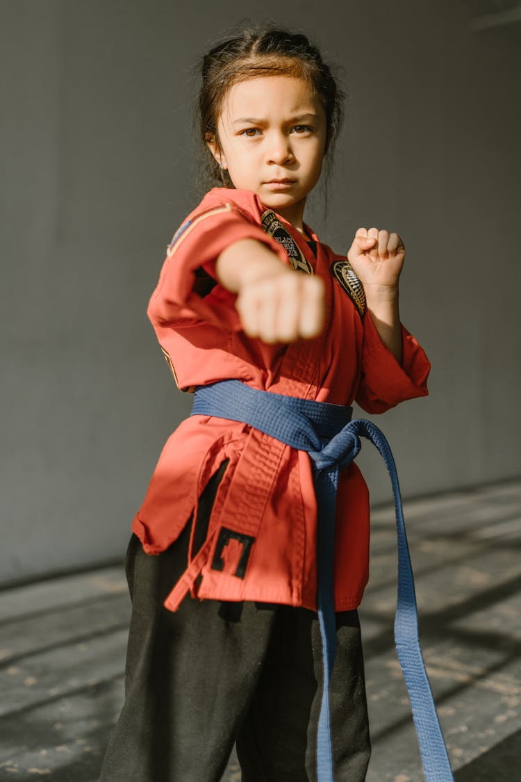 Close-Up Shot Of A Girl Wearing Red Dobok And Blue Belt