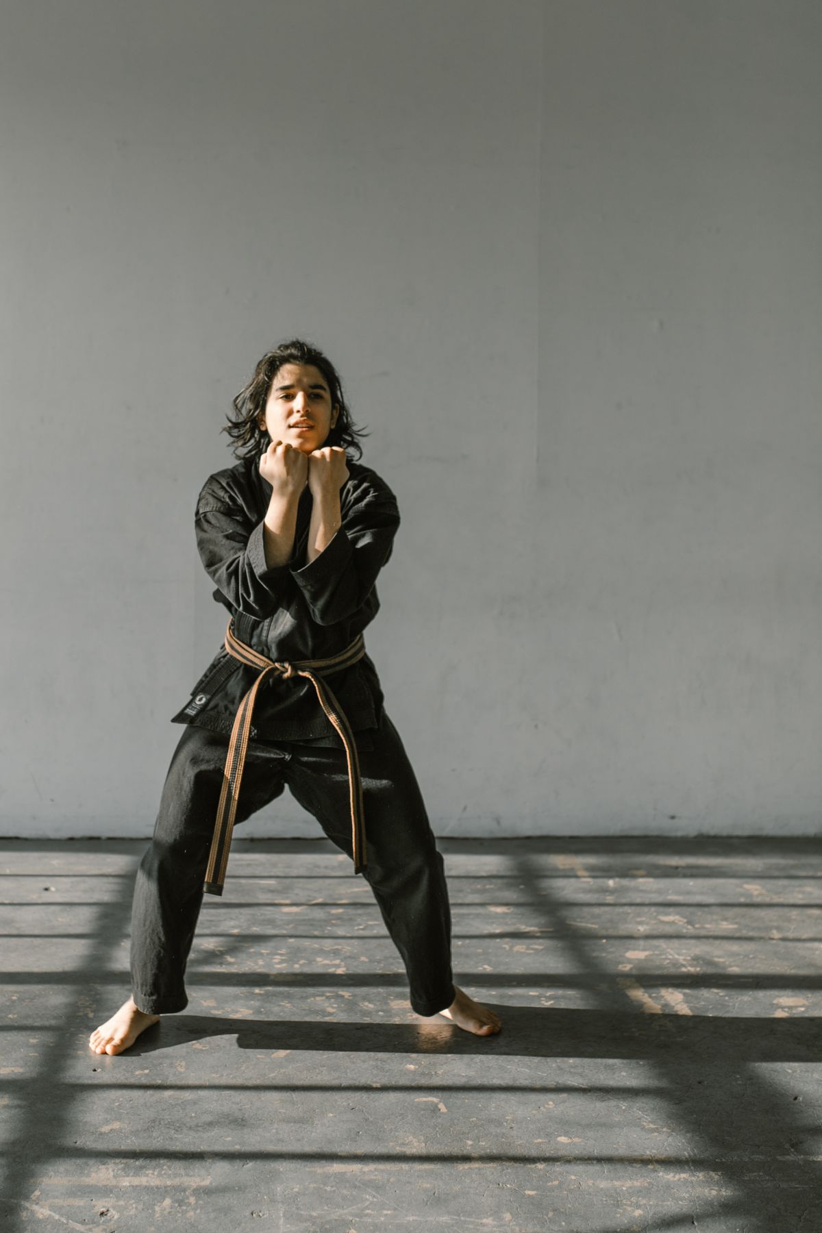 Martial arts practitioners in traditional white dobok holding balanced horse stance