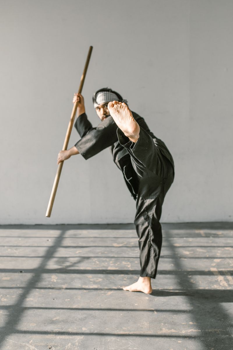 Martial artist training solo with a staff