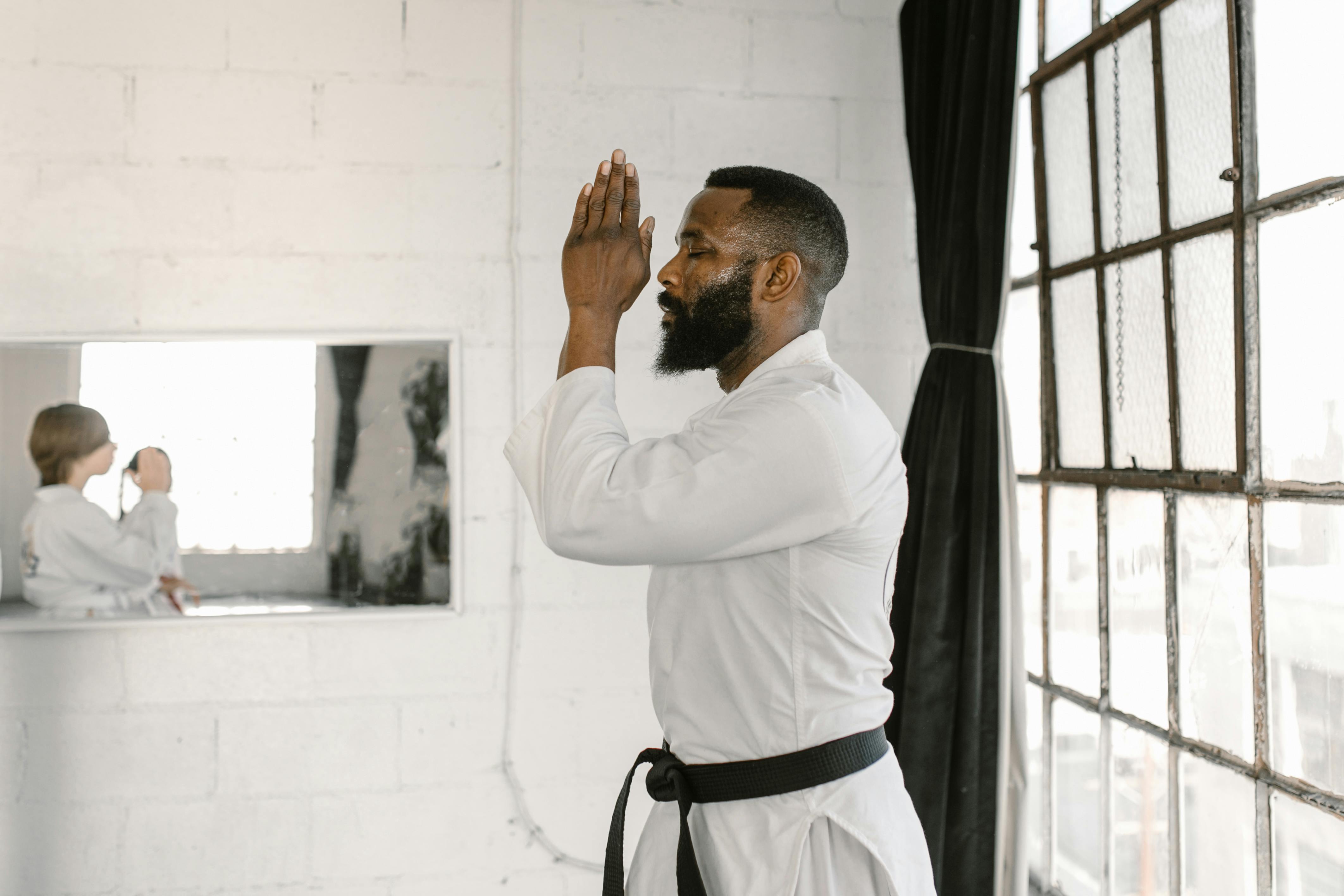 man in white dress shirt covering his face