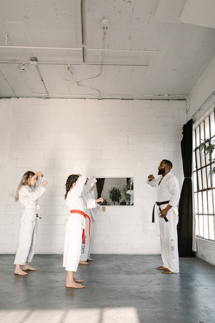 Man Teaching The Girls The Basic Karate Moves 