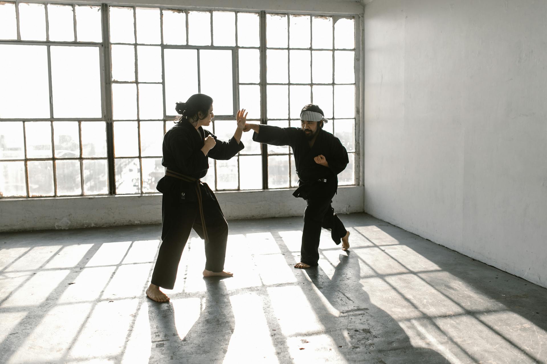 A Person Throwing a Punch on the Long Haired Man