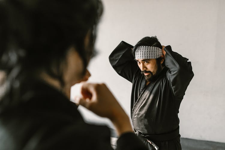 A Man In Black Gi Wearing Bandana