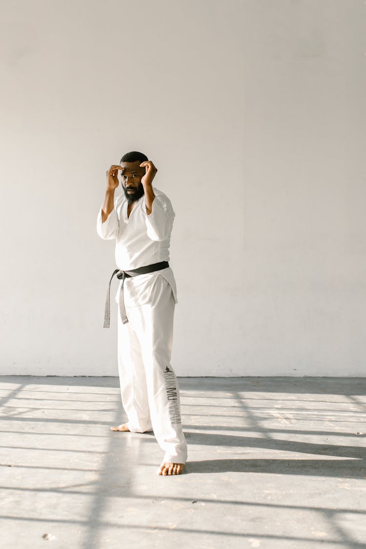 A Man Standing With His Hands Near His Face 