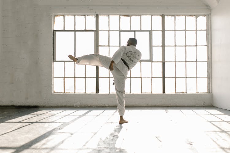 Back View Of A Man Doing A Side Kick 