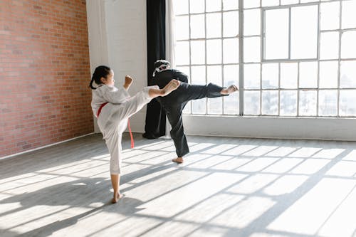 Free Photo of a Man and Child Practicing Taekwondo Stock Photo