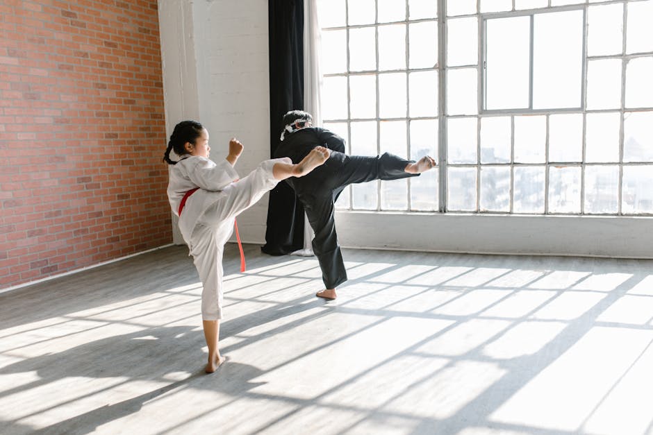 Photo of a Man and Child Practicing Taekwondo