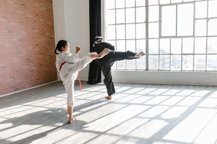 Photo Of A Man And Child Practicing Taekwondo