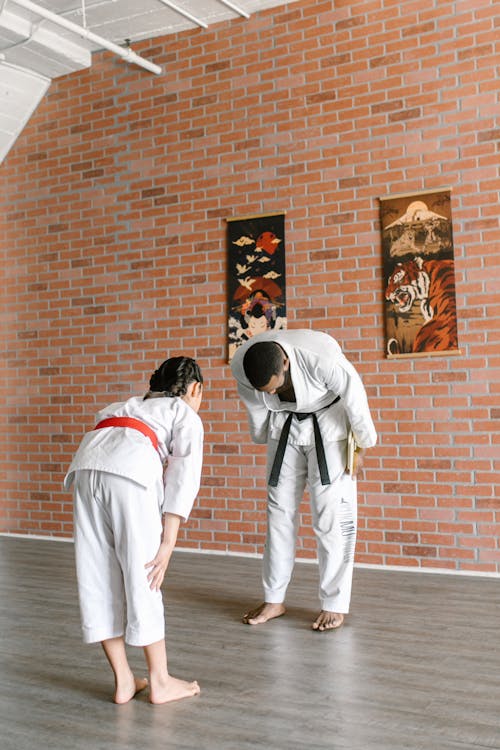 Free Man and Girl In Martial Arts Bowing Down  Stock Photo