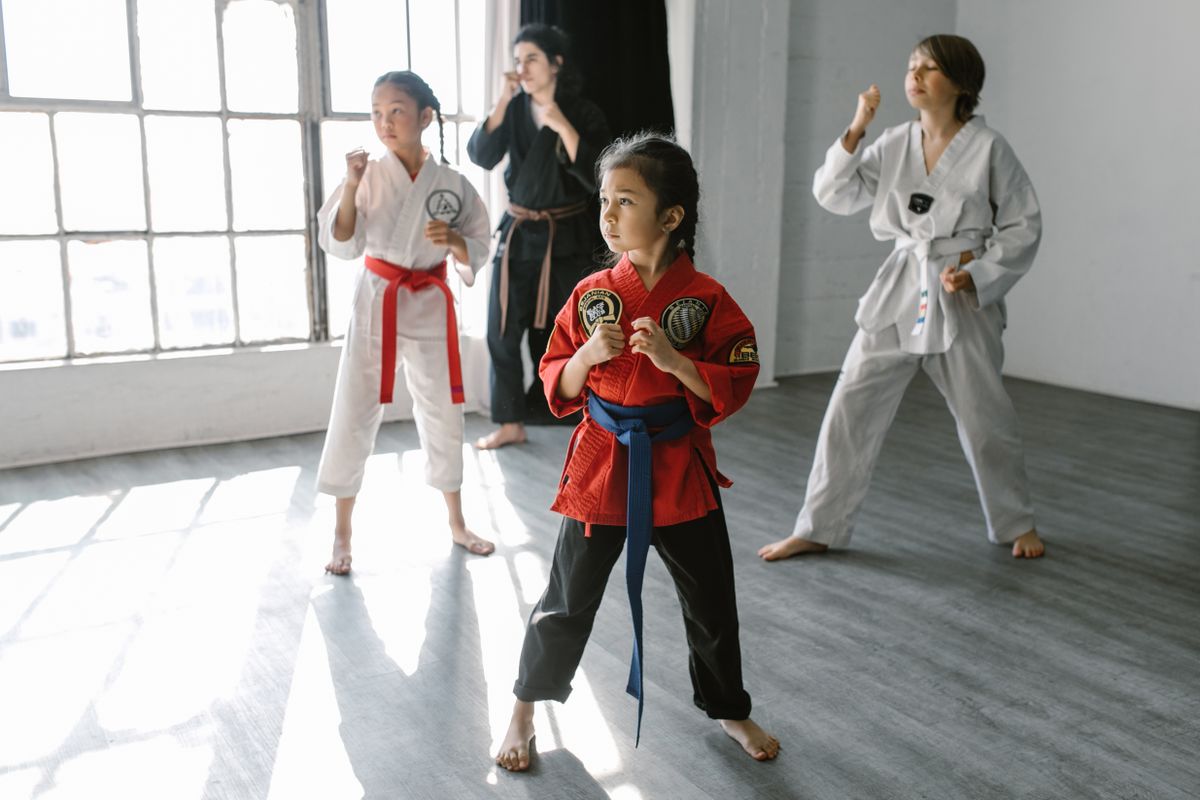 Group of children learning martial arts together in a class.