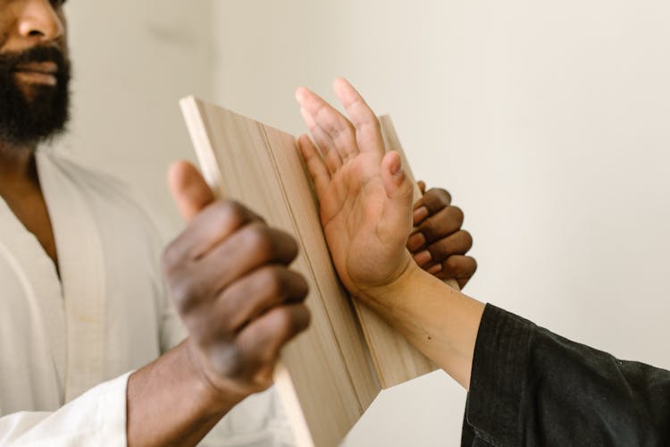 Person Holding Brown Wooden Board