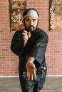 A Bearded Man in Black Uniform Doing a Karate Position