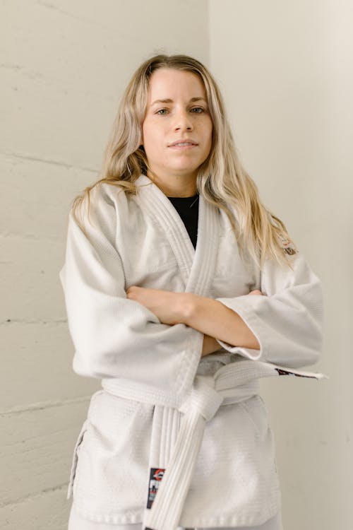 Free A Woman in Taekwondo Uniform with Her Arms Crossed Stock Photo