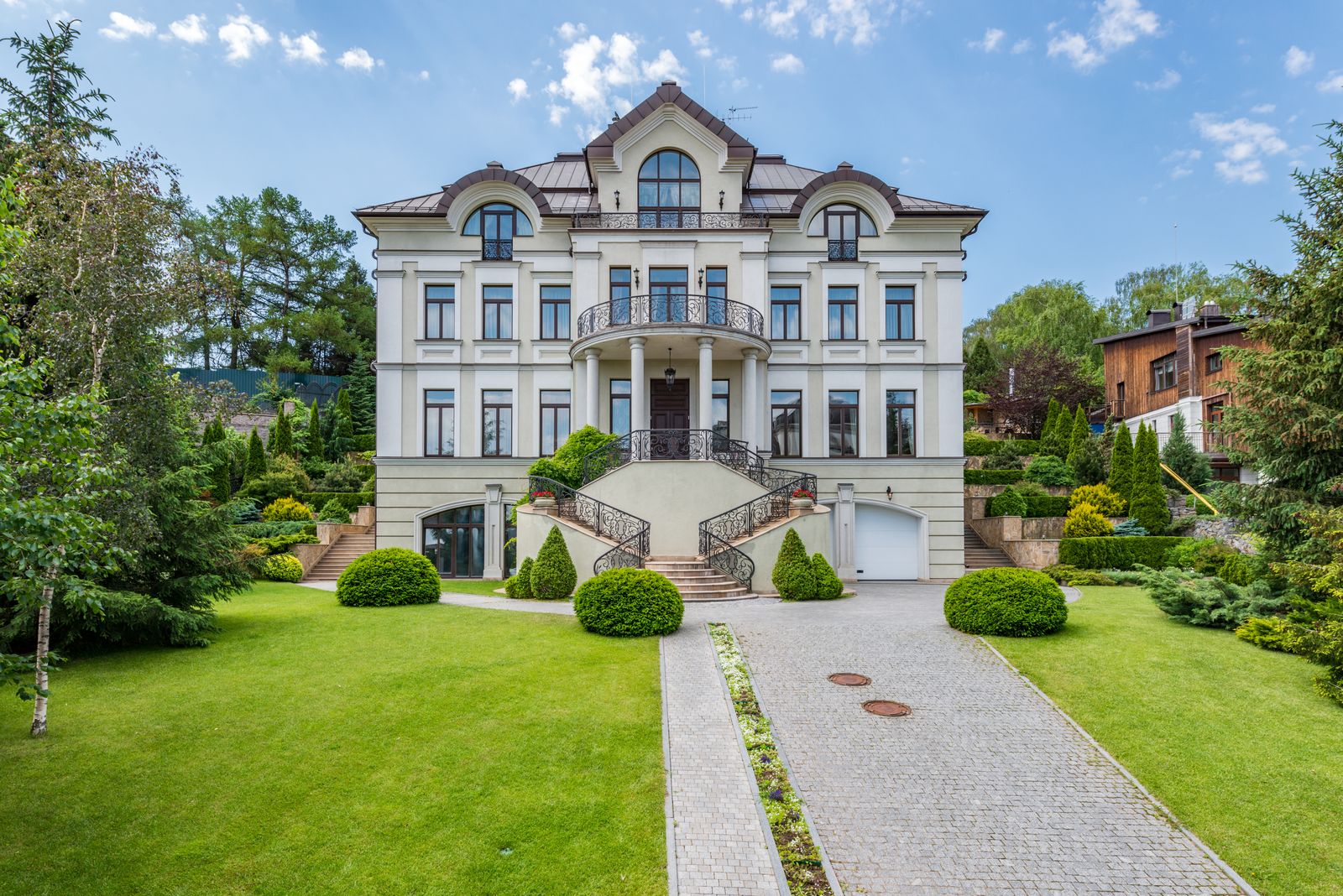 Classic estate home with a broad lawn and landscaped entry