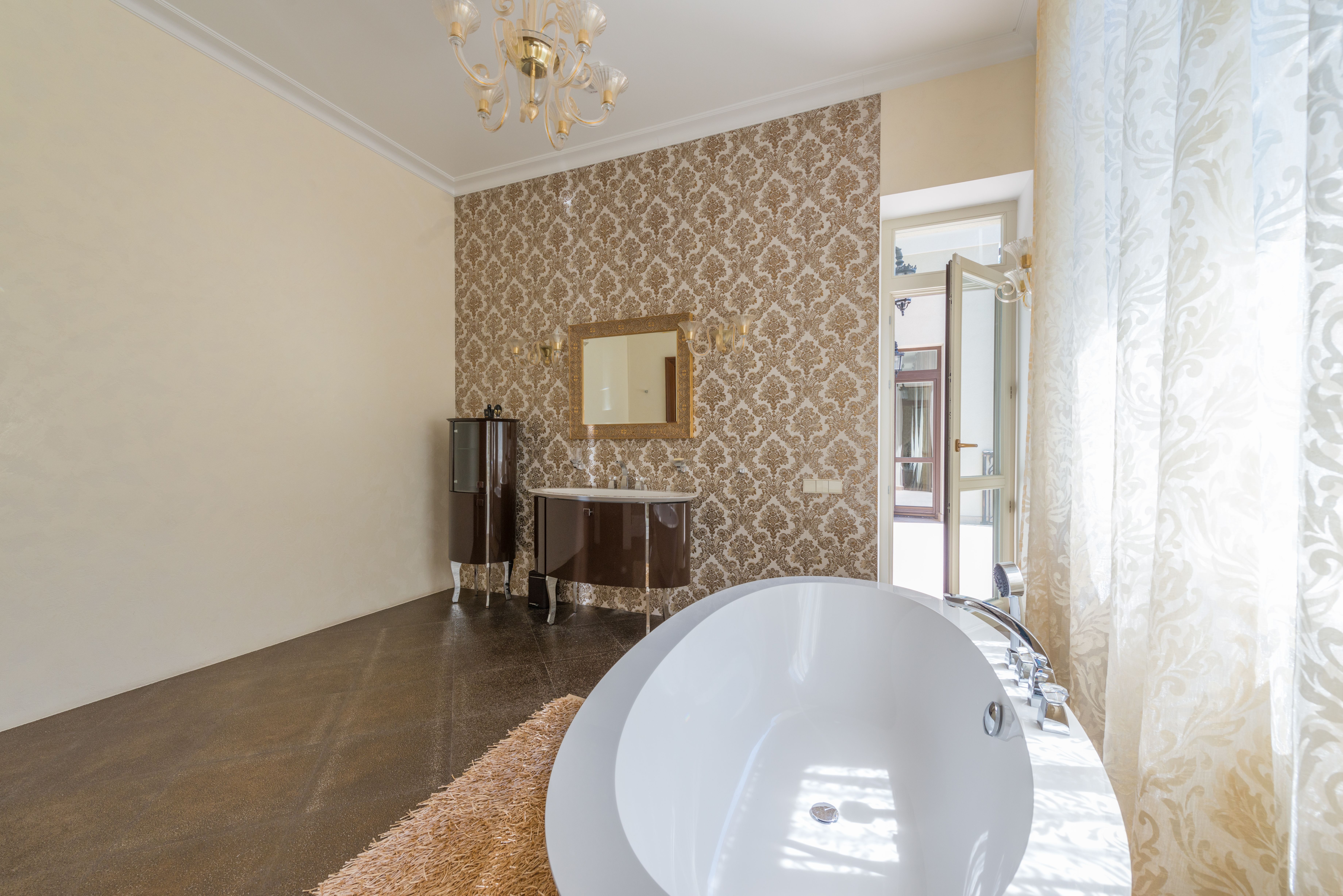 Wallpapering in Bulls Cross — a decorator at work mid-project