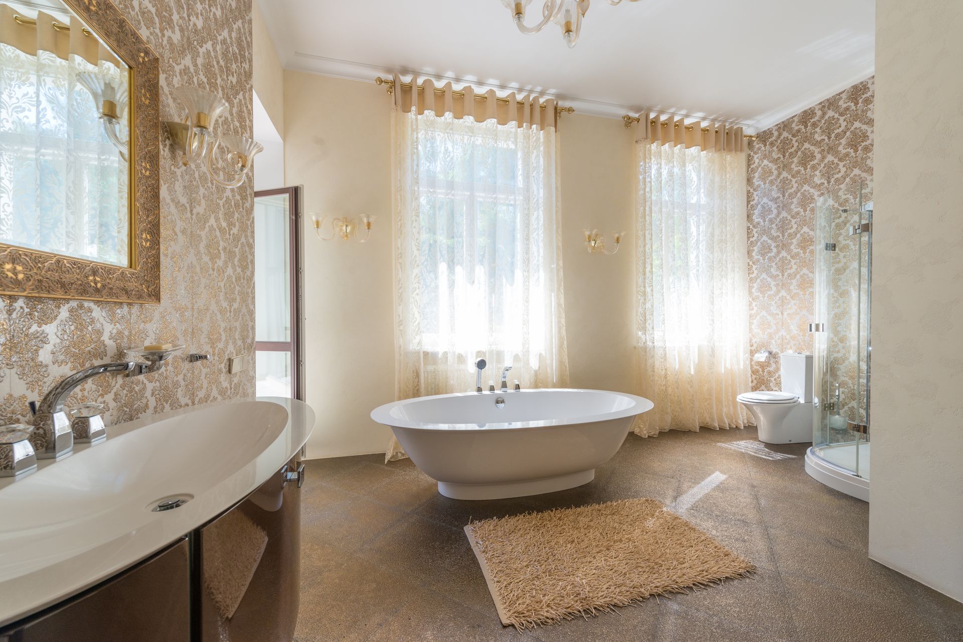 Interior of spacious contemporary bathroom with oval shaped sink with metal shiny faucet under mirror reflecting interior