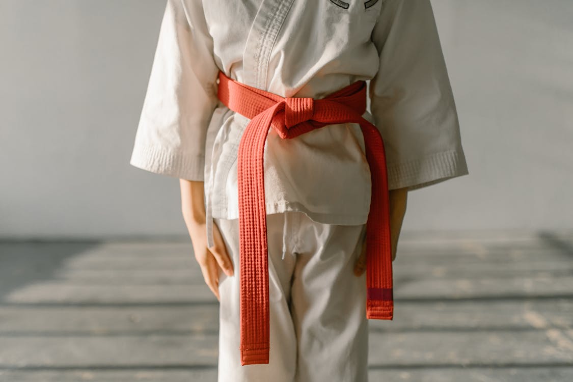 Wearing a Karate Uniform Orange Belt · Free Stock Photo