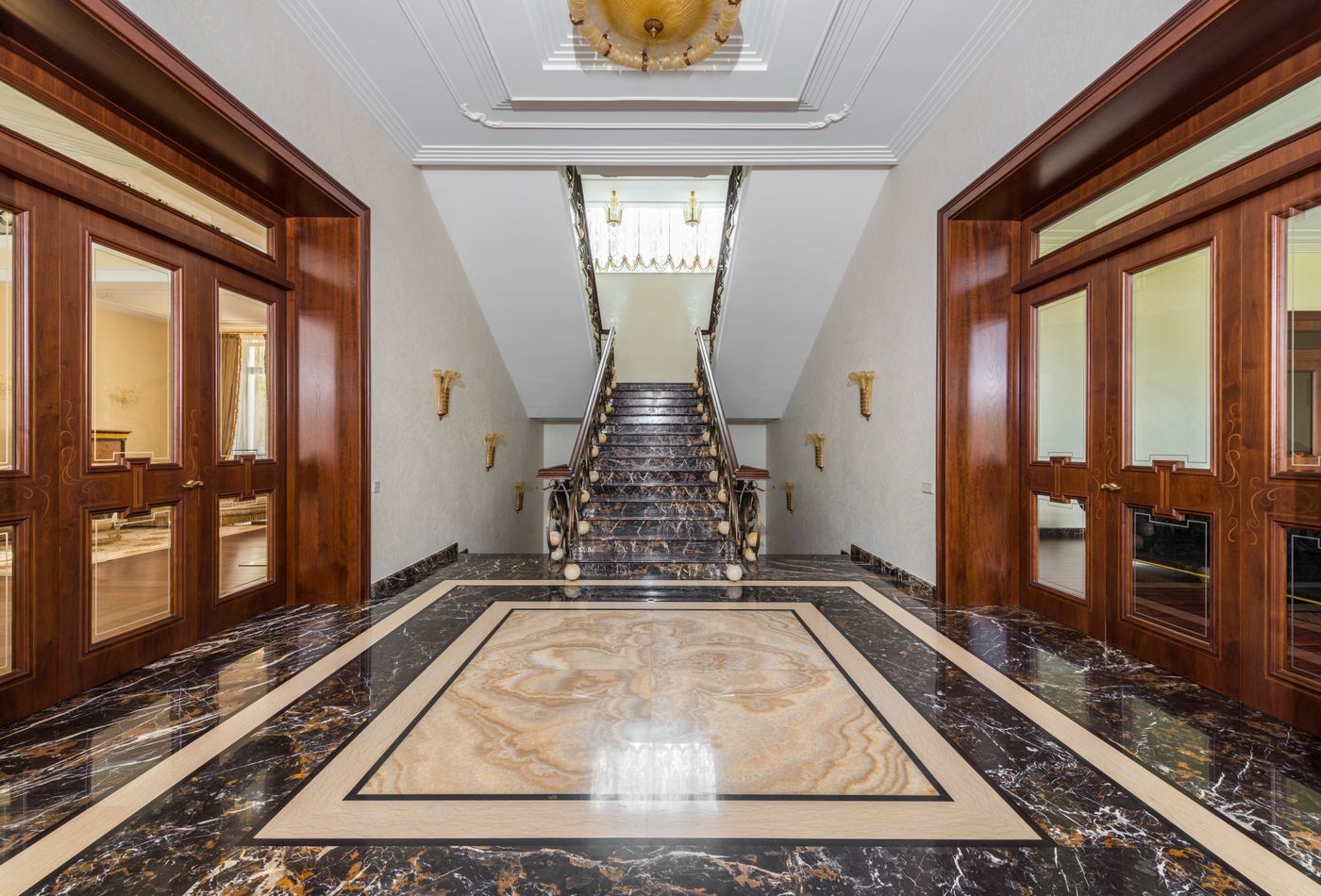 Spacious corridor with marble floor and stairway