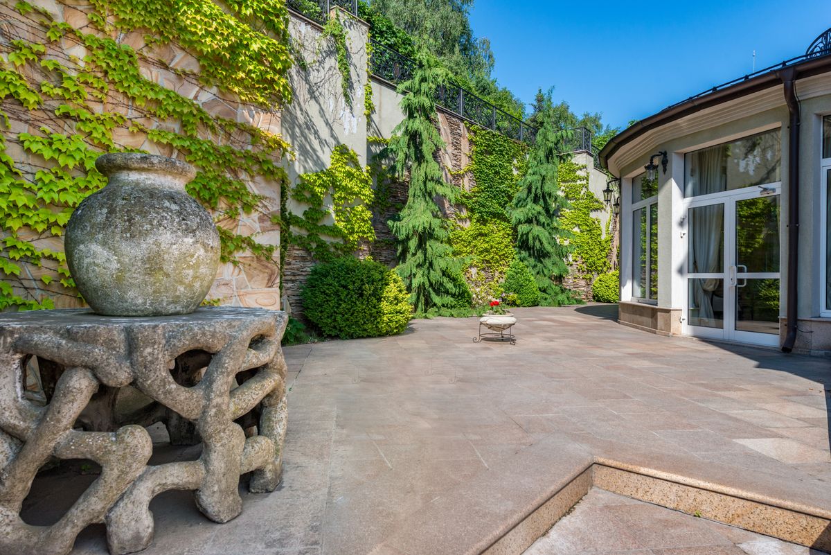 Sausalito Villa Entry — stone-accented residential exterior with garden and aged stone detail