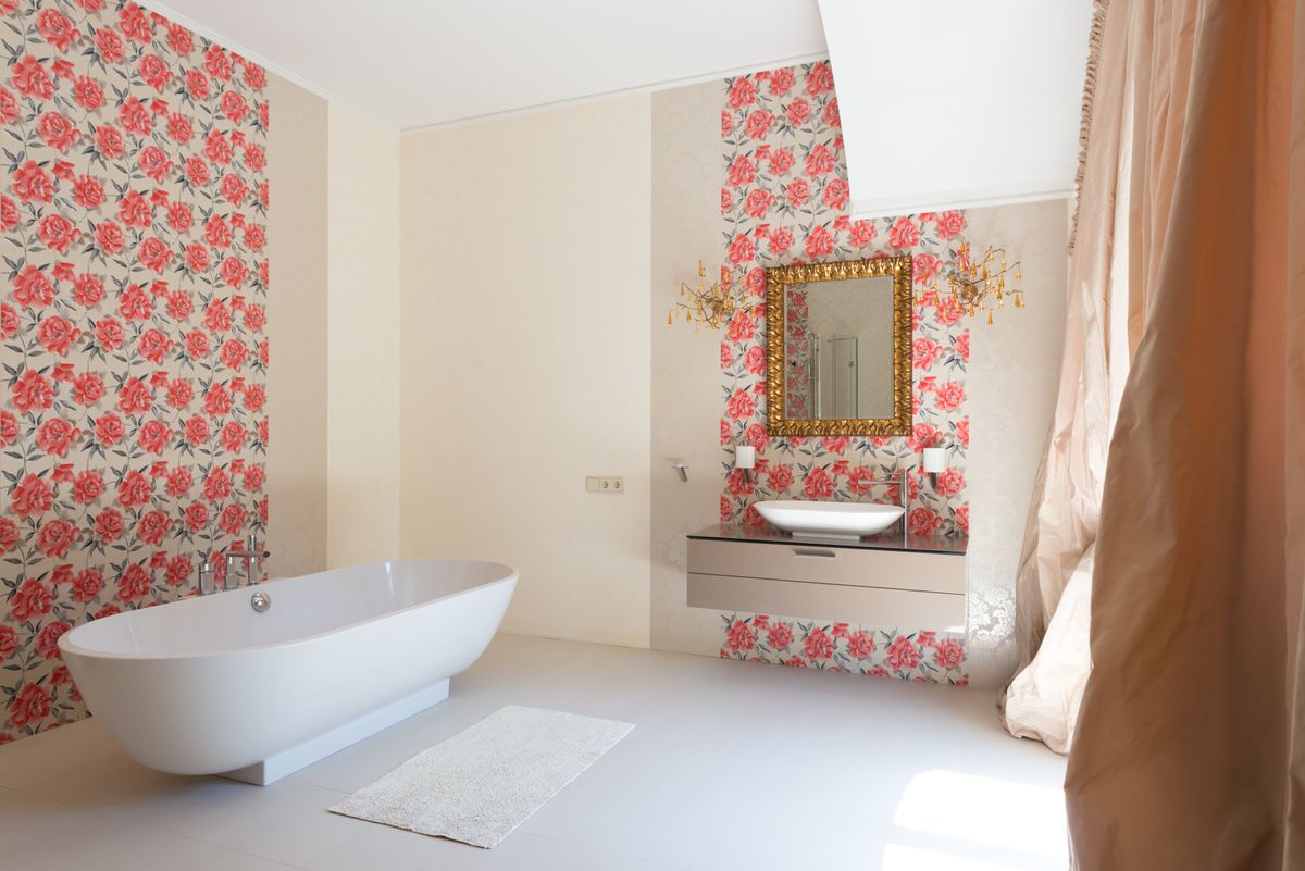 A bathroom interior with sink and mirror near a bathtub for bathroom cabinet organization ideas
