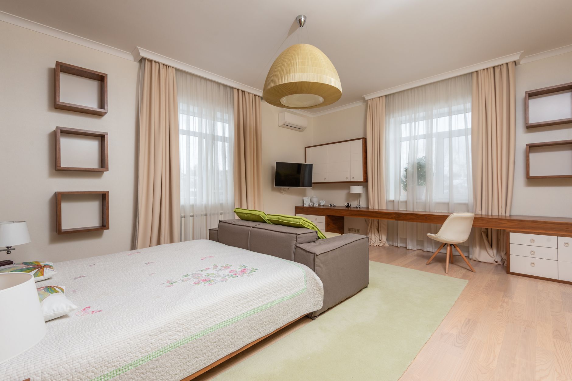 Interior of modern apartment with beige curtains and brown wooden table with white chair