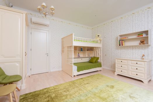 Contemporary interior of large children bedroom with green carpet and white bed with cushions and blanket