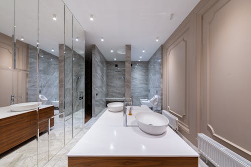 Interior of empty stylish light bathroom with mirrored cabinet placed in modern apartment